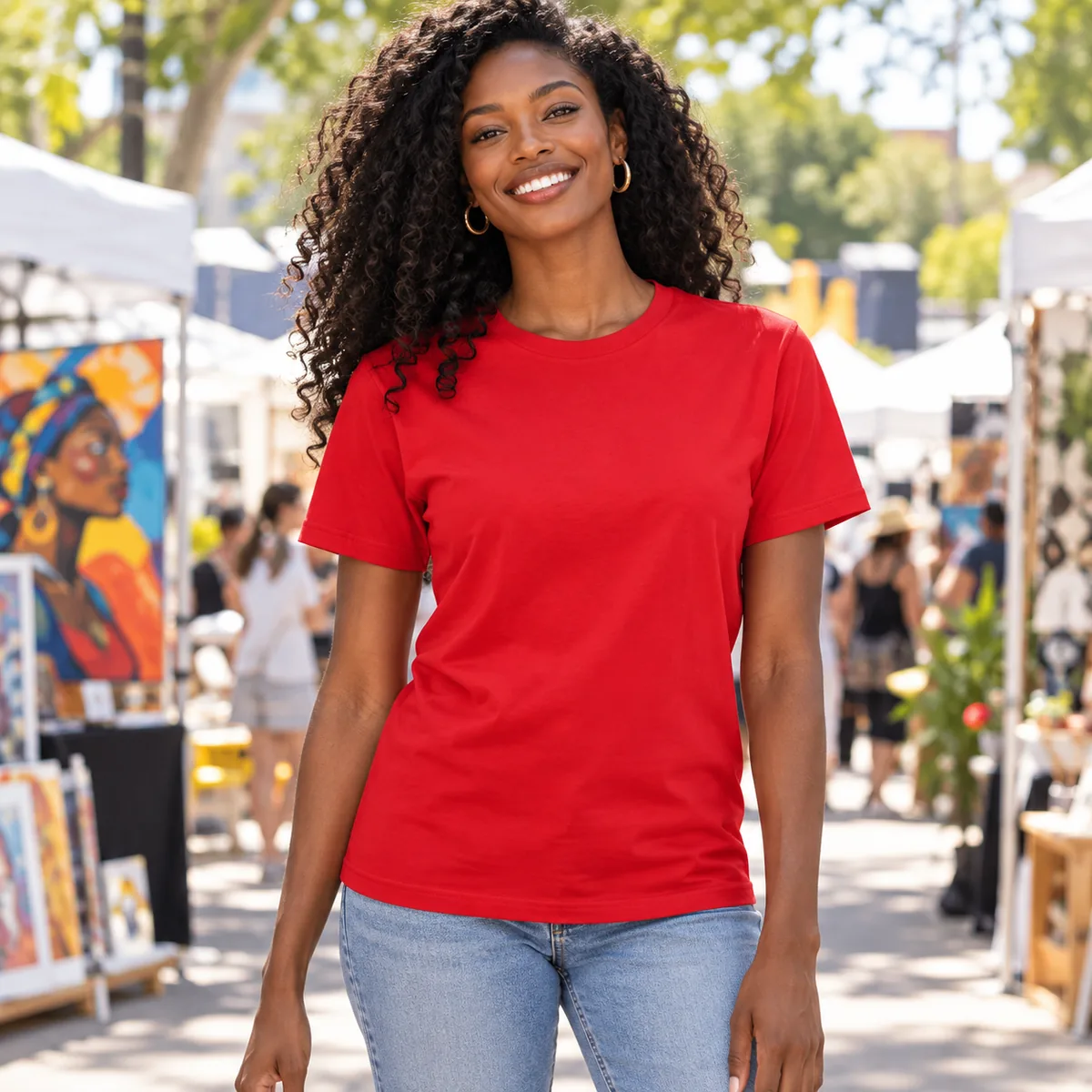 Woman wearing a revolution red Allmade organic cotton tee at a community arts festival; blank front.