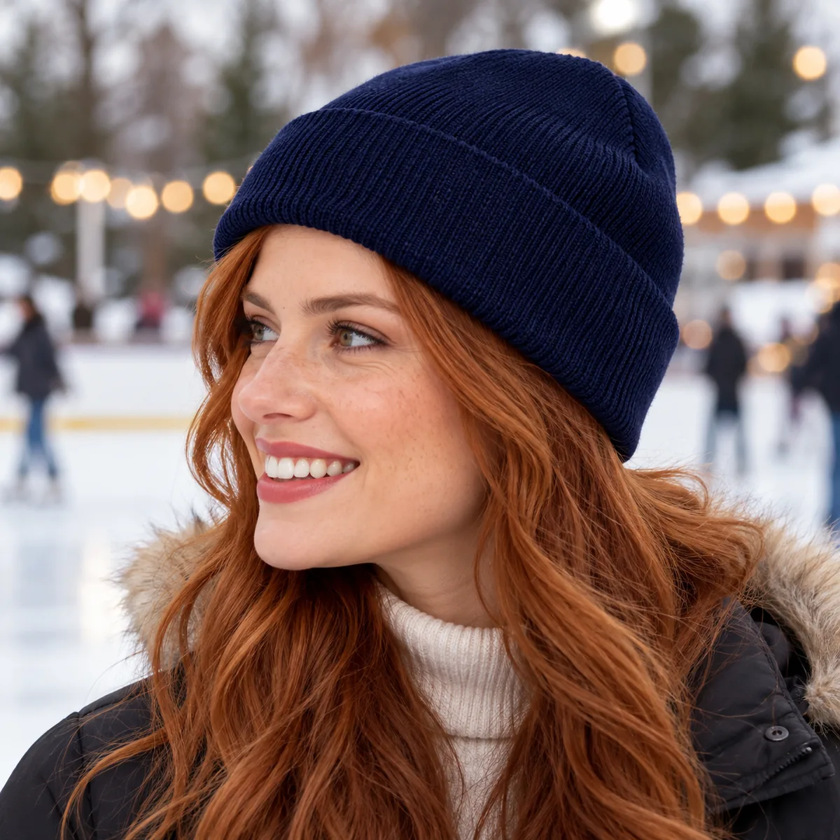 Woman wearing a navy blue blank cuffed beanie at an outdoor ice rink, shown in profile.