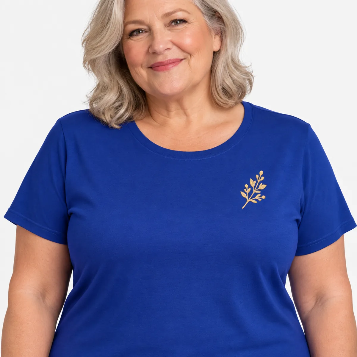 Close view of a woman wearing the deep royal District Soft-Touch Women’s T-shirt with a small gold sprig sample detail.
