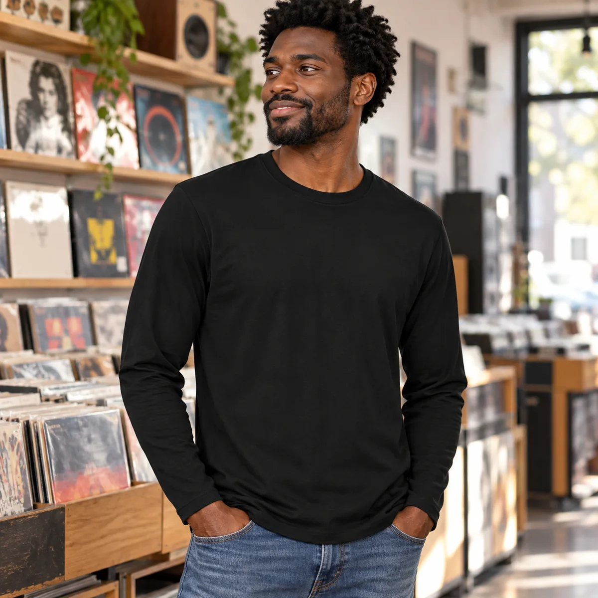 Man wearing the black District Very Important Tee long sleeve at a record store; blank front view.