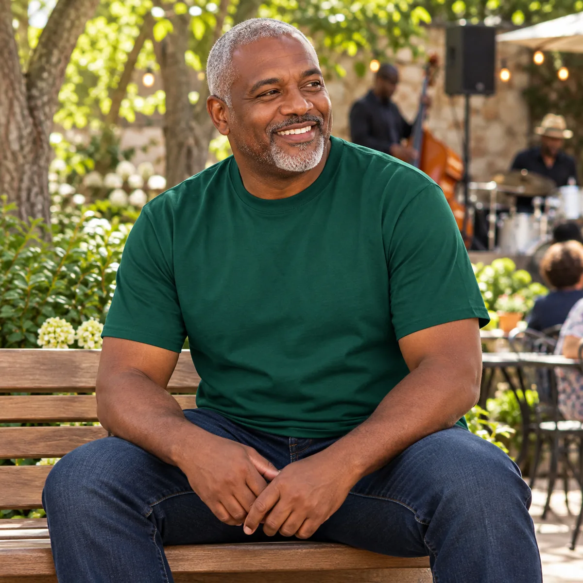 Model wearing an evergreen District Very Important Tee in a jazz courtyard.