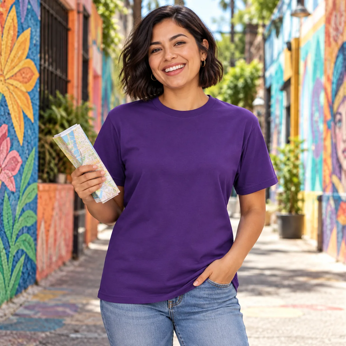 Model wearing a purple District Very Important Tee in a colorful mural alley.