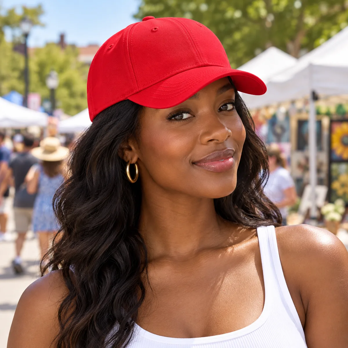 Woman wearing a red blank Flexfit cap at a neighborhood street fair.