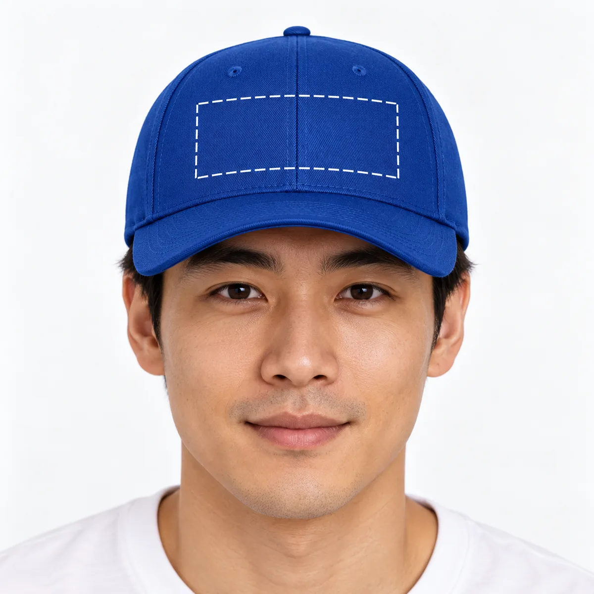 Man wearing a royal blue Flexfit cap with an illustrative dashed front-panel embroidery placement guide; dimensions are not verified.