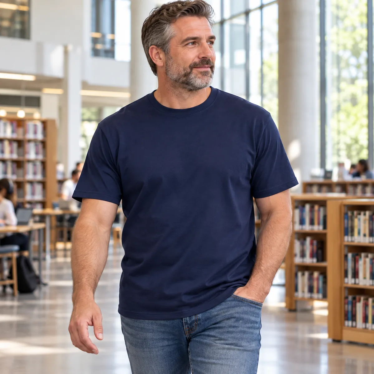 Model wearing the navy Gildan Budget unisex T-shirt in a modern public library.