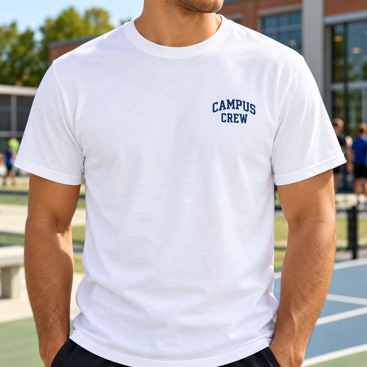 Close view of a white Gildan DryBlend T-shirt with fictional Campus Crew sample print at a sports center.