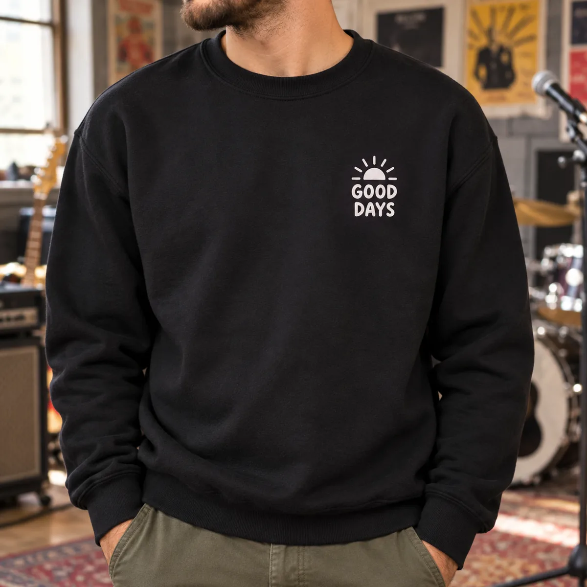Close view of a black sweatshirt with fictional Good Days sample print in a rehearsal room.
