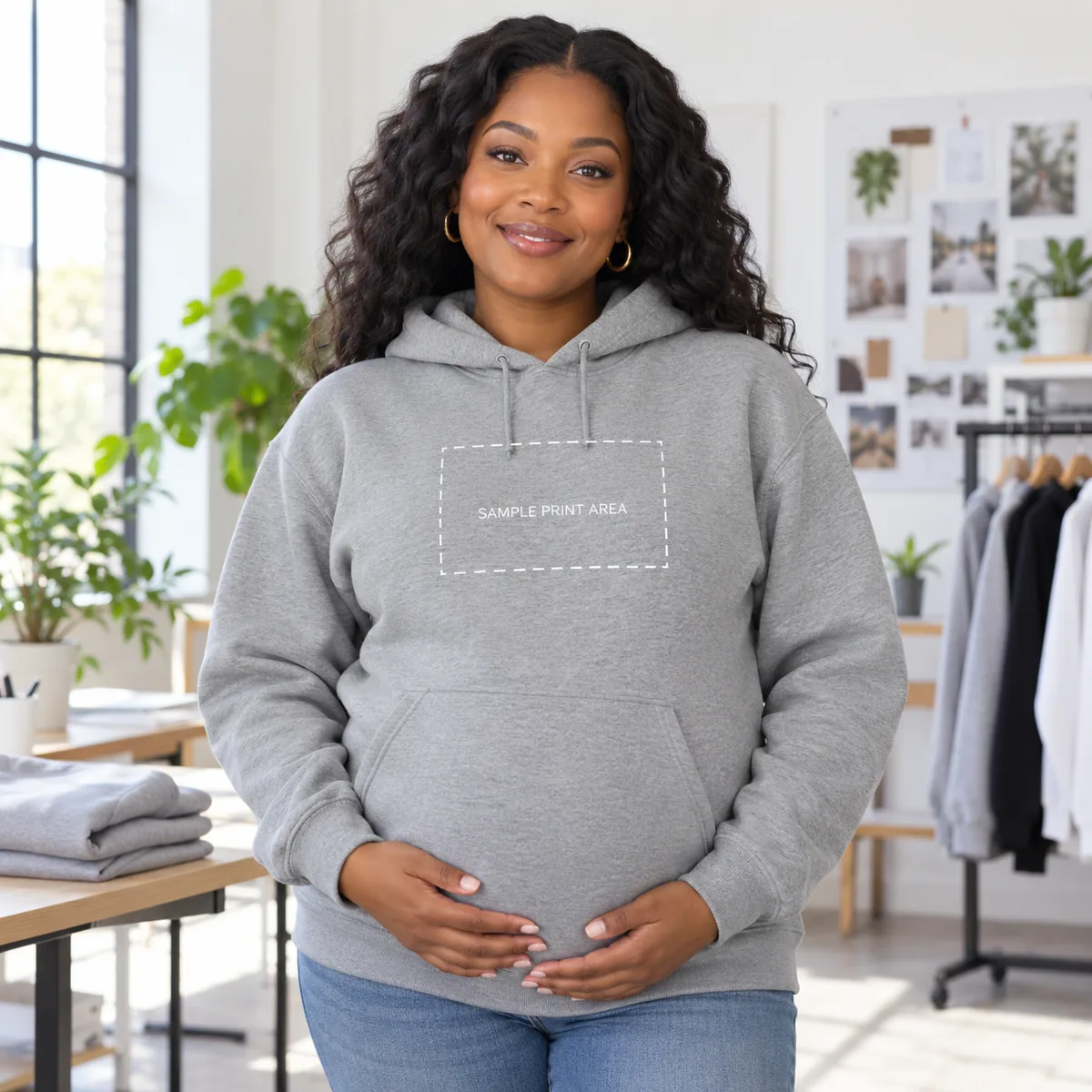 Pregnant Black woman wearing an Oxford JERZEES NuBlend hoodie with an illustrative chest print-area guide; dimensions are not verified.