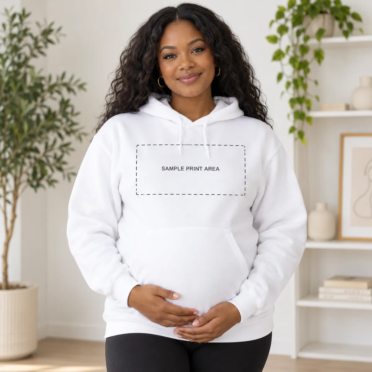Pregnant Black woman wearing a white hoodie with an illustrative chest print-area guide; dimensions are not verified.