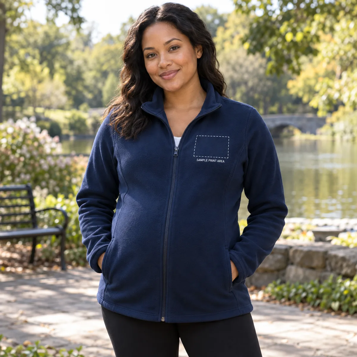 Pregnant woman wearing a true navy fleece jacket with an illustrative dashed chest print-area guide; dimensions are not verified.