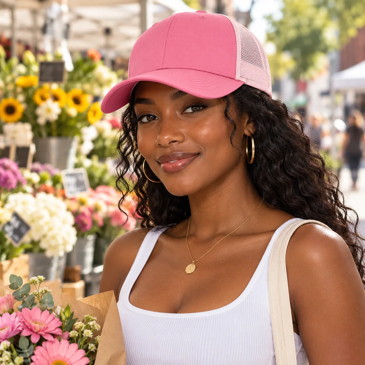 Woman wearing a pink blank Yupoong trucker cap at a flower market.